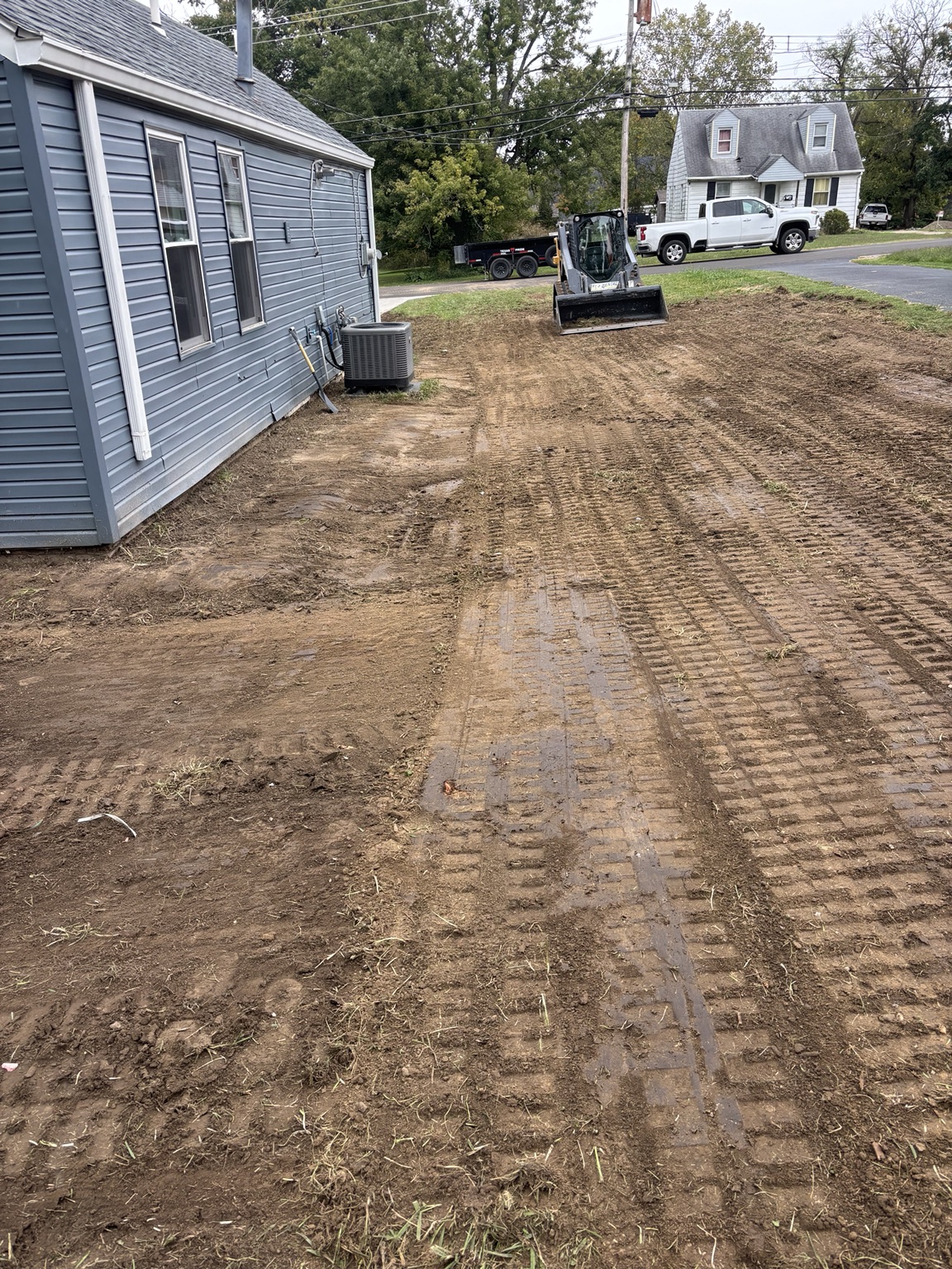 Yard after grading to establish positive drainage away from foundation